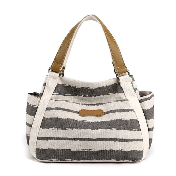 Stylish one-shoulder tote bag with spacious canvas design and elegant stripe pattern.