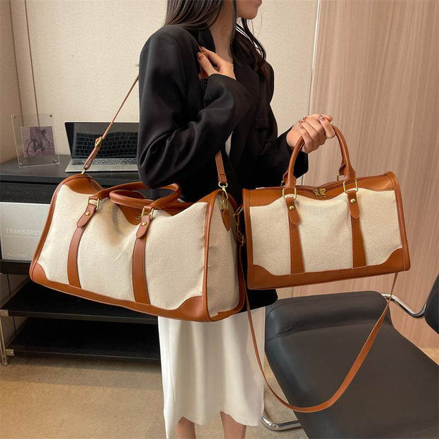 Woman holding large and small capacity purses in stylish brown and beige design, featuring leather straps and ample storage space.