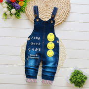 Children overalls with smiley face design and adjustable straps, featuring durable material and multiple pockets for infants aged 1-3 years.