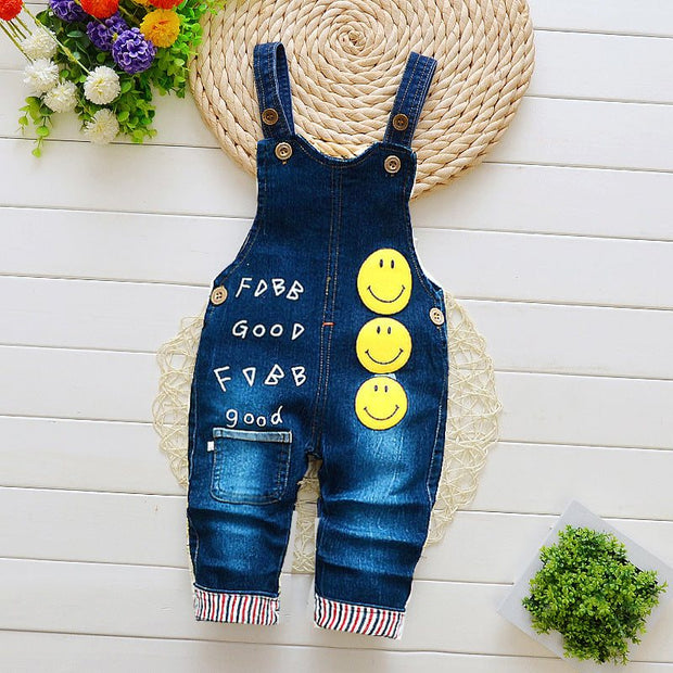 Children overalls with smiley face design and adjustable straps, featuring durable material and multiple pockets for infants aged 1-3 years.