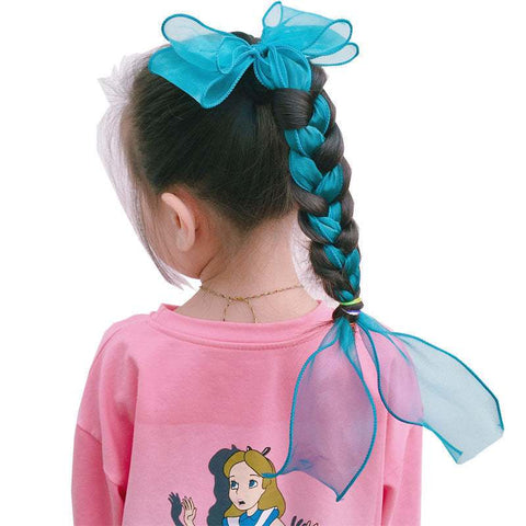 Children's bow hairpin in vibrant blue color adorning a braided hairstyle.