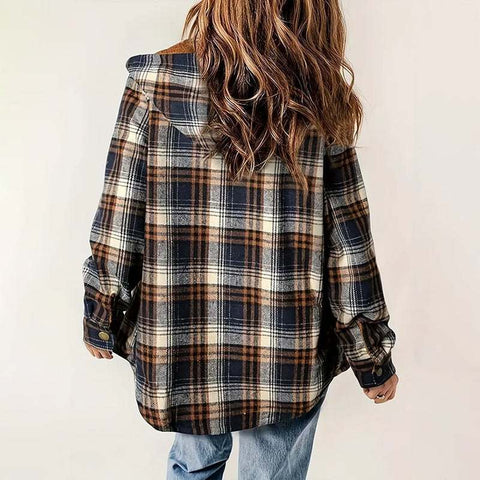 Back view of a plaid hooded fleece-lined jacket in brown, black, and cream tones worn by a person with long hair.