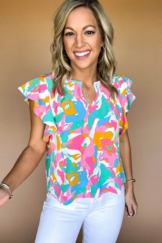 Multicolored abstract ruffle blouse with short flutter sleeves and vibrant print.