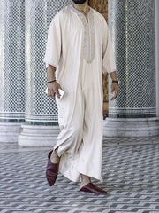 Embroidery White Muslim Robe with intricate detail and milky white fabric.