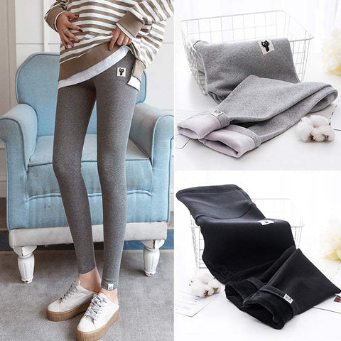 Fleece-lined maternity leggings in dark gray and black, featuring stretchy fabric and cozy fleece lining for pregnancy comfort.