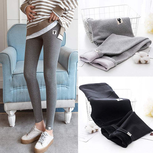 Fleece-lined maternity leggings in dark gray and black, featuring stretchy fabric and cozy fleece lining for pregnancy comfort.