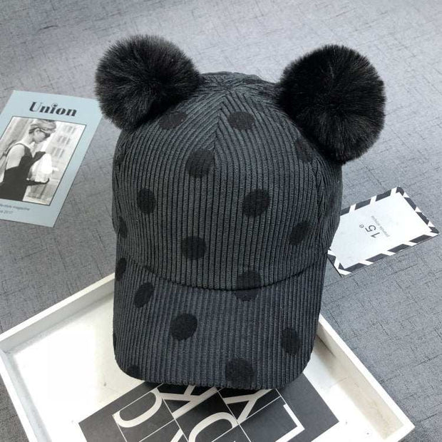 Ball Peaked Hat with two pom-poms, dark gray with dot pattern, stylish sun protection accessory.