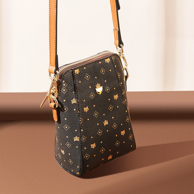 Crossbody Phone Bag by Foxer in brown with adjustable strap, PVC/microfiber material, chic and compact design.