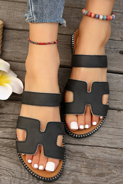 Black leather H band slides with cushioned footbed for stylish comfort.