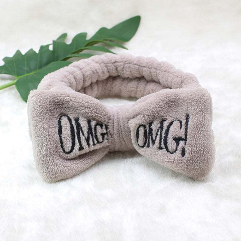 Coral Velvet Butterfly Hair Band with 'OMG!' embellishment on plush fabric.