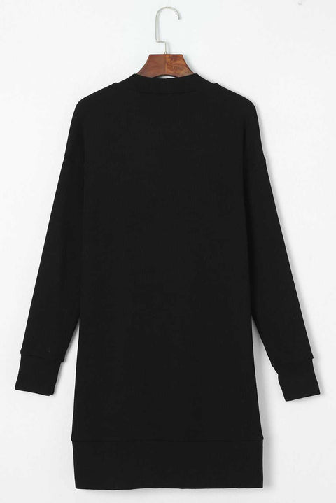 Black pocketed open front cardigan displayed on a hanger.