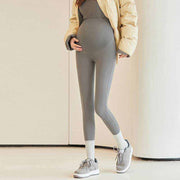 Fleece-lined maternity pants with stretchy waistband for comfort during pregnancy.