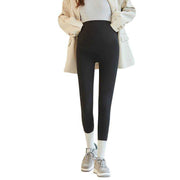 Fleece-lined maternity pants with stretchy waistband and sleek design.