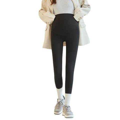 Fleece-lined maternity pants with stretchy waistband and sleek design.
