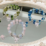 Colorful Fairy Beads Butterfly Bracelets with whimsical butterfly charms displayed on a mirror.