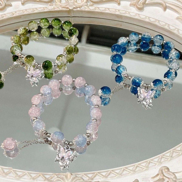 Colorful Fairy Beads Butterfly Bracelets with whimsical butterfly charms displayed on a mirror.