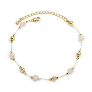 Delicate charm bracelet with gold and stone beads, perfect for self-expression and individuality.