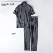 Gray two-piece home wear suit hanging on wall, featuring cozy top and matching bottoms for comfort and style.