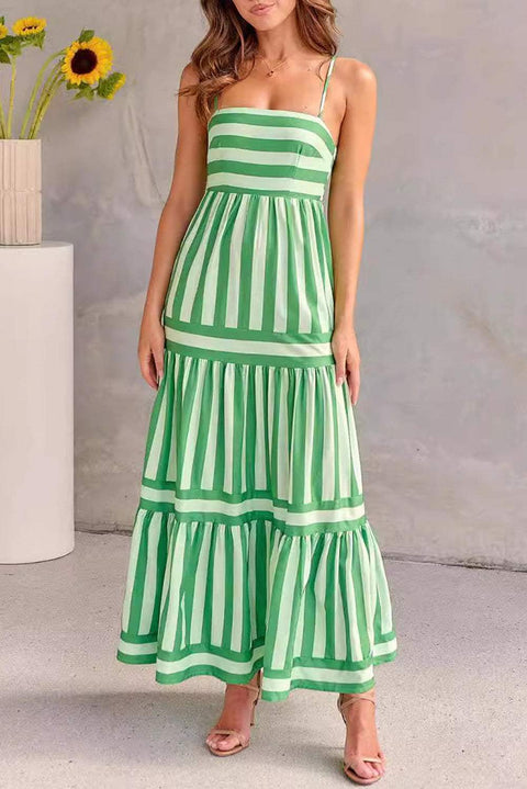 Green striped smocked dress with spaghetti straps and tiered skirt displayed on a model.