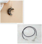Moon Tree of Life Necklace with crystal pendant and black leather rope, showcasing celestial design and adjustable fit.
