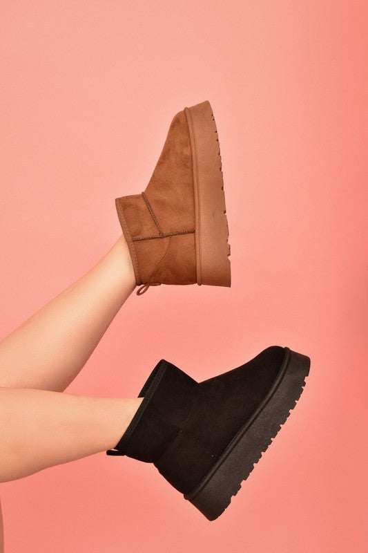 WILD DIVA Suede Platform Booties in brown and black on legs, stylish footwear with platform sole for comfort and height.
