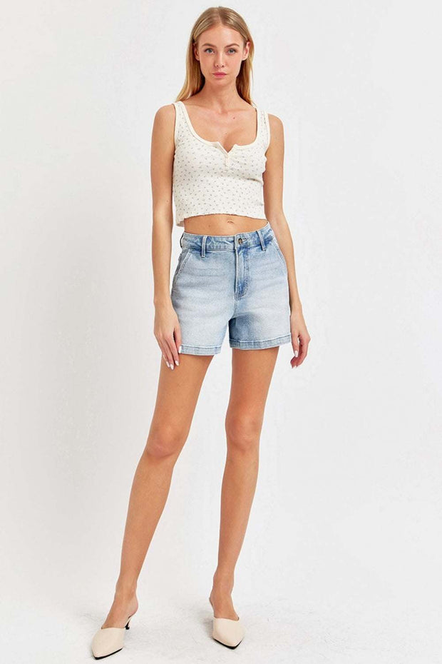 RISEN Denim Shorts with a mid-rise waist, styled with a white top, showcasing comfort and versatility.