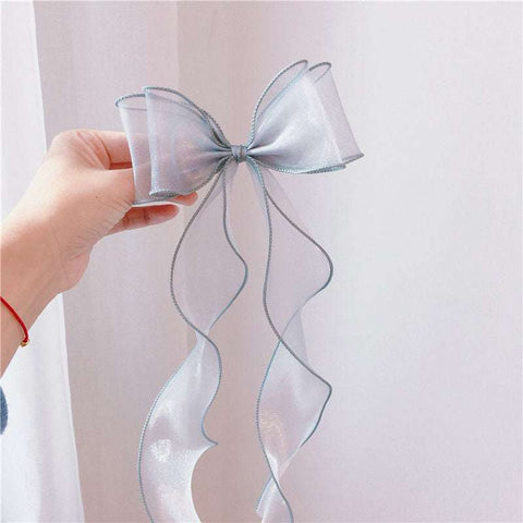 Children's bow hairpin with lace and playful design.