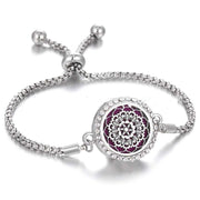 Hollow stainless steel aromatherapy bracelet with intricate design and adjustable band.