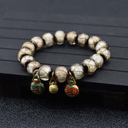 Gray Colored Glaze Bracelet with geometric design and dangling charms.
