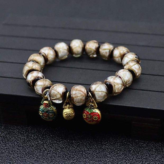 Gray Colored Glaze Bracelet with geometric design and dangling charms.