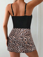 Woman wearing a printed scoop-neck wide-strap one-piece swimwear with leopard print skirt bottom viewed from back