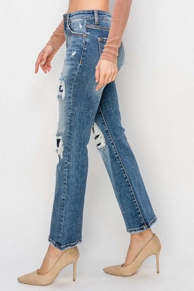 Woman wearing RISEN Distressed Flare Jeans showing side view with noticeable distressed details, paired with nude heels.