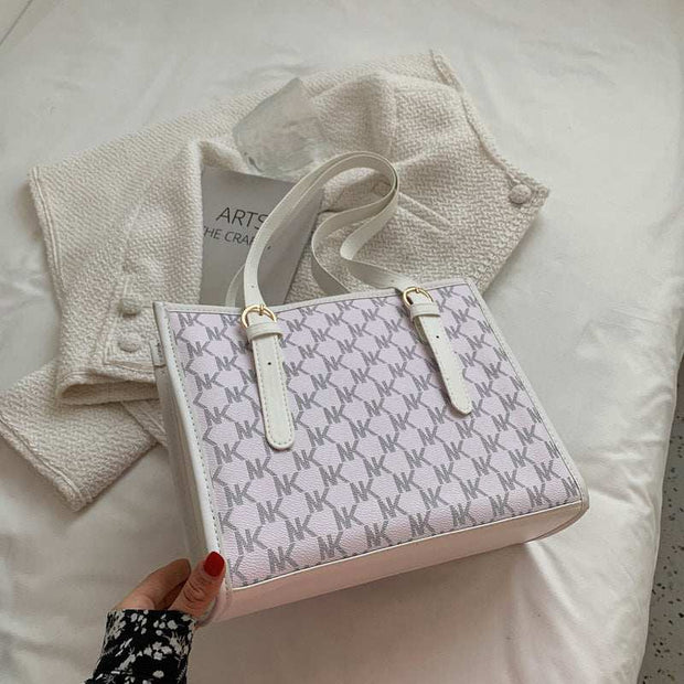 Elegant white large capacity handbag with patterned design and sturdy handles.