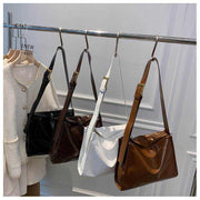 Retro Crossbody Commuter Tote in black, brown, white displayed on hangers; urban style handbag for daily commuting.