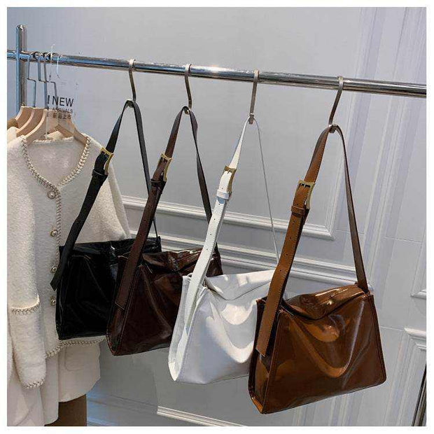 Retro Crossbody Commuter Tote in black, brown, white displayed on hangers; urban style handbag for daily commuting.