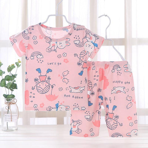Youth pajama set with fun animal prints and pink background on hanger.