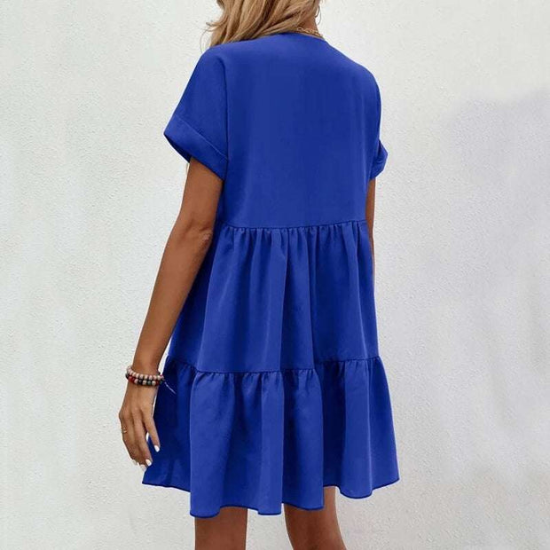 Fashionable short-sleeved V-neck dress in vibrant blue with a flowy skirt.