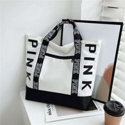 Large Capacity Handbag in black and white with printed handles, featuring a spacious design ideal for everyday use.