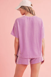 Orange Ribbed Tee and Shorts Set in vibrant orange with ribbed texture, featuring a loose-fit tee and matching shorts, ideal for casual wear.