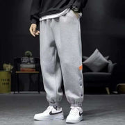 Casual velvet padded pants in gray with elastic waistband and ankle cuffs, worn with white sneakers.