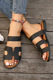 Black leather H band slides with cushioned footbed for casual and dressy occasions.