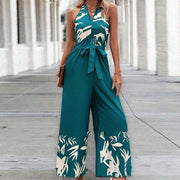 Fashionable woman wearing a Backless Halter Jumpsuit with a floral pattern, showcasing elegance and style.