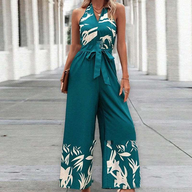Fashionable woman wearing a Backless Halter Jumpsuit with a floral pattern, showcasing elegance and style.