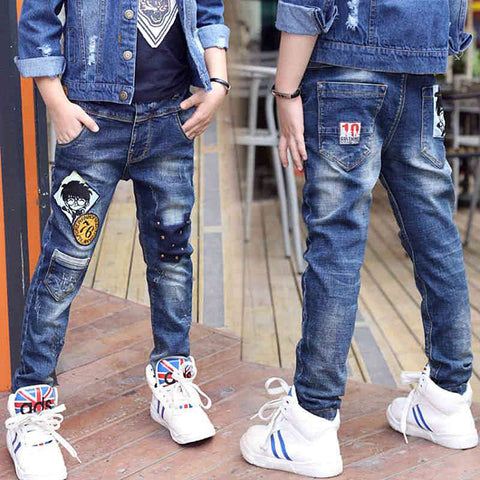 Boys wearing stylish denim jeans with patches, blue wash, versatile fit; ideal for trendy, casual outings.