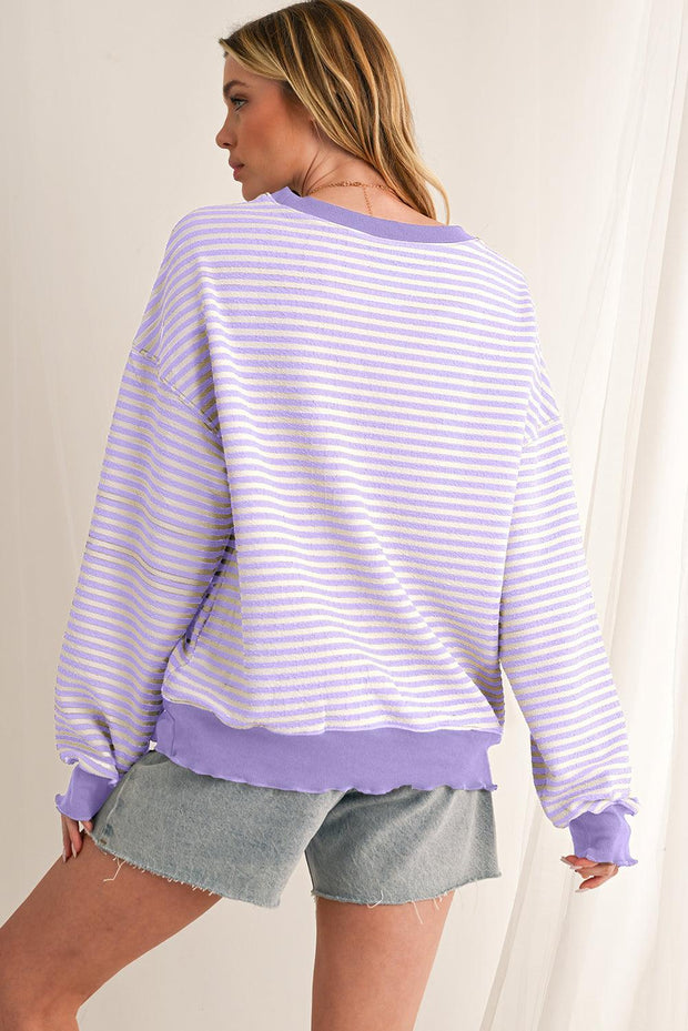 Trendy pink stripe drop shoulder top with relaxed fit and soft fabric.