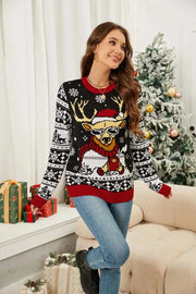 Woman wearing a Christmas pattern long sleeve sweater with reindeer design in festive living room