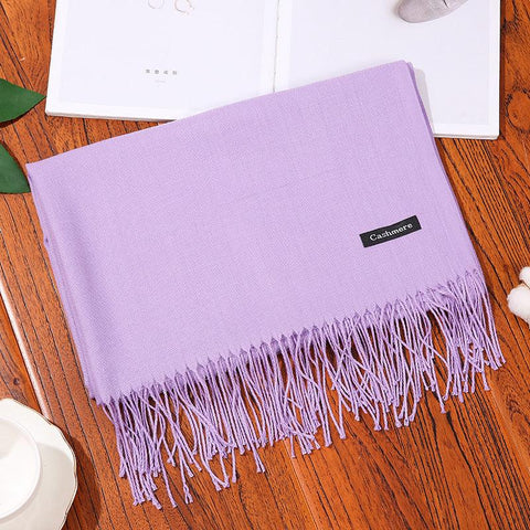 Designer Scarf Shawl in lavender with fringe detailing on a wooden table.