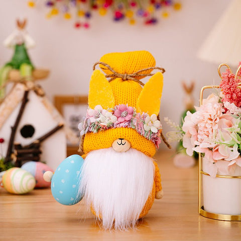 Easter Knit Faceless Doll with flower crown, colorful knit design, and decorative Easter egg accessory on wooden table.