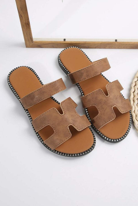 Brown leather H band slides on a white background.