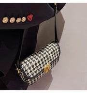 Houndstooth Baguette Bag with classic pattern and shoulder strap.